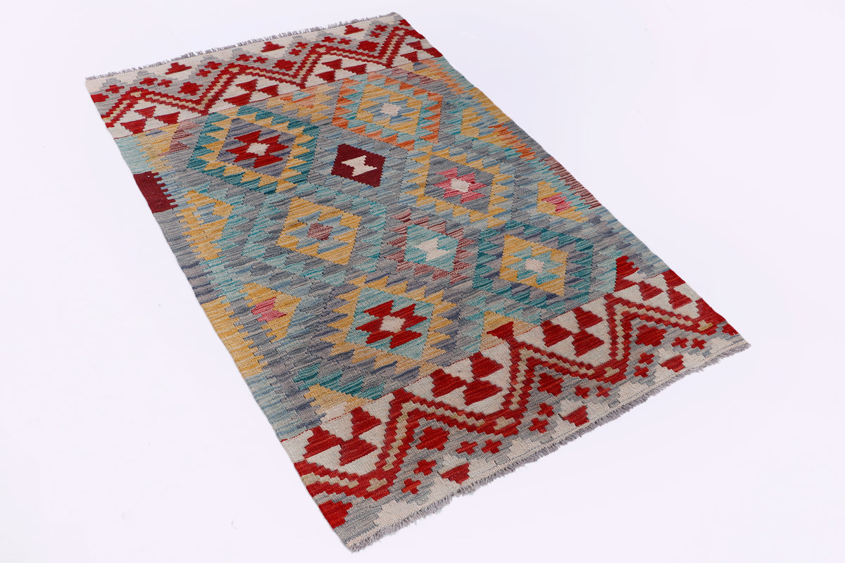 Geometric kilim rug, grey base with red and blue accents, laid flat for showing