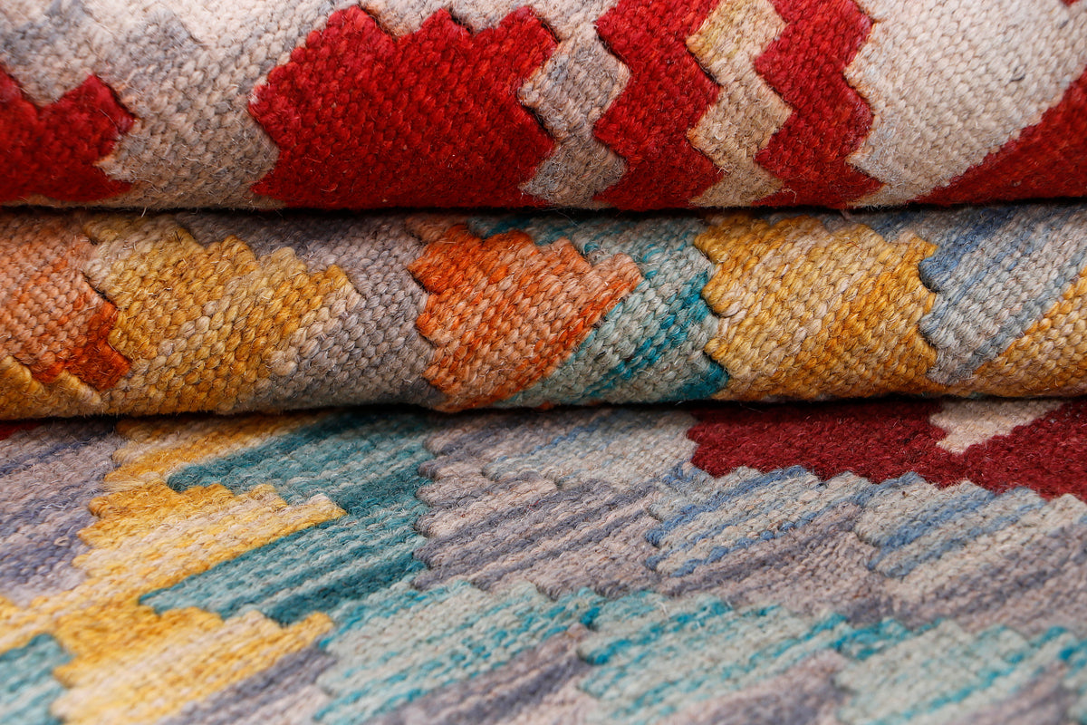 Kilim rug folded edge detail showing woven texture in red, blue, and grey