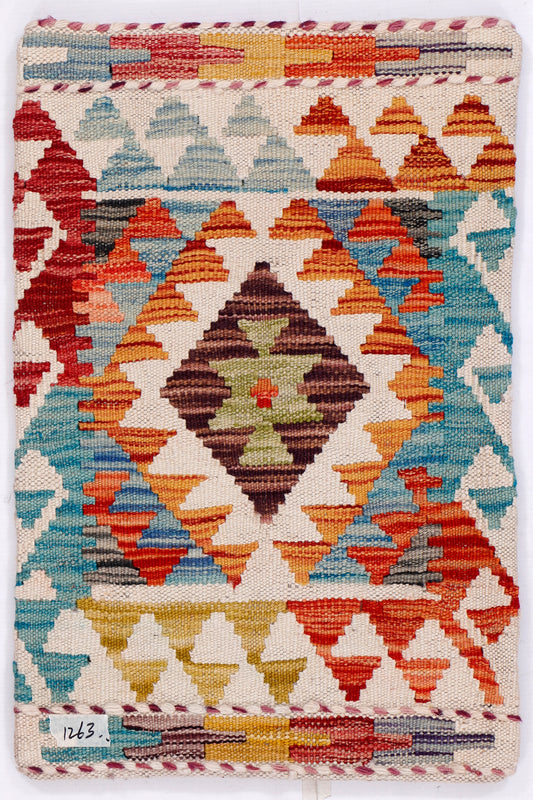 Turquoise kilim cushion cover front with geometric pattern in red, orange, cream, 35x55 cm