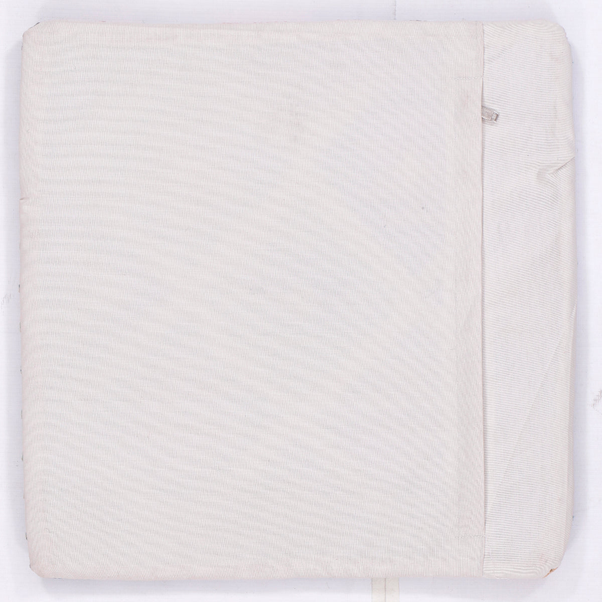 Light cream kilim cushion cover back with subtle woven texture and side seam, 45x45 cm
