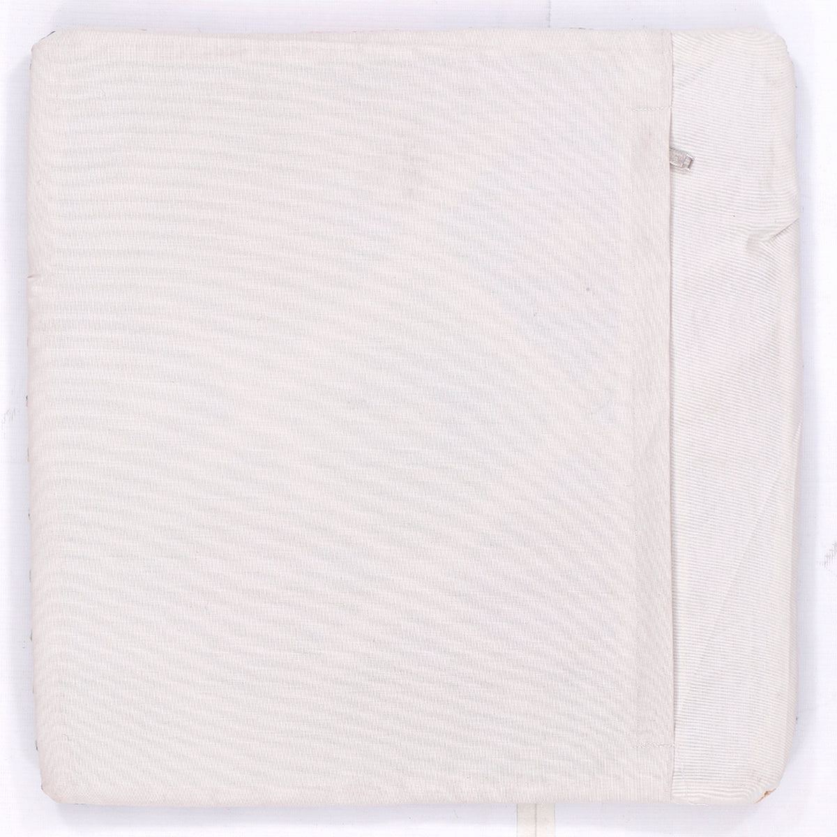Square kilim cushion back, solid off-white fabric with stitched edge and seam