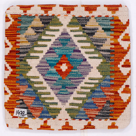 Kilim cushion cover close-up: orange border with multicolor geometric medallion on white