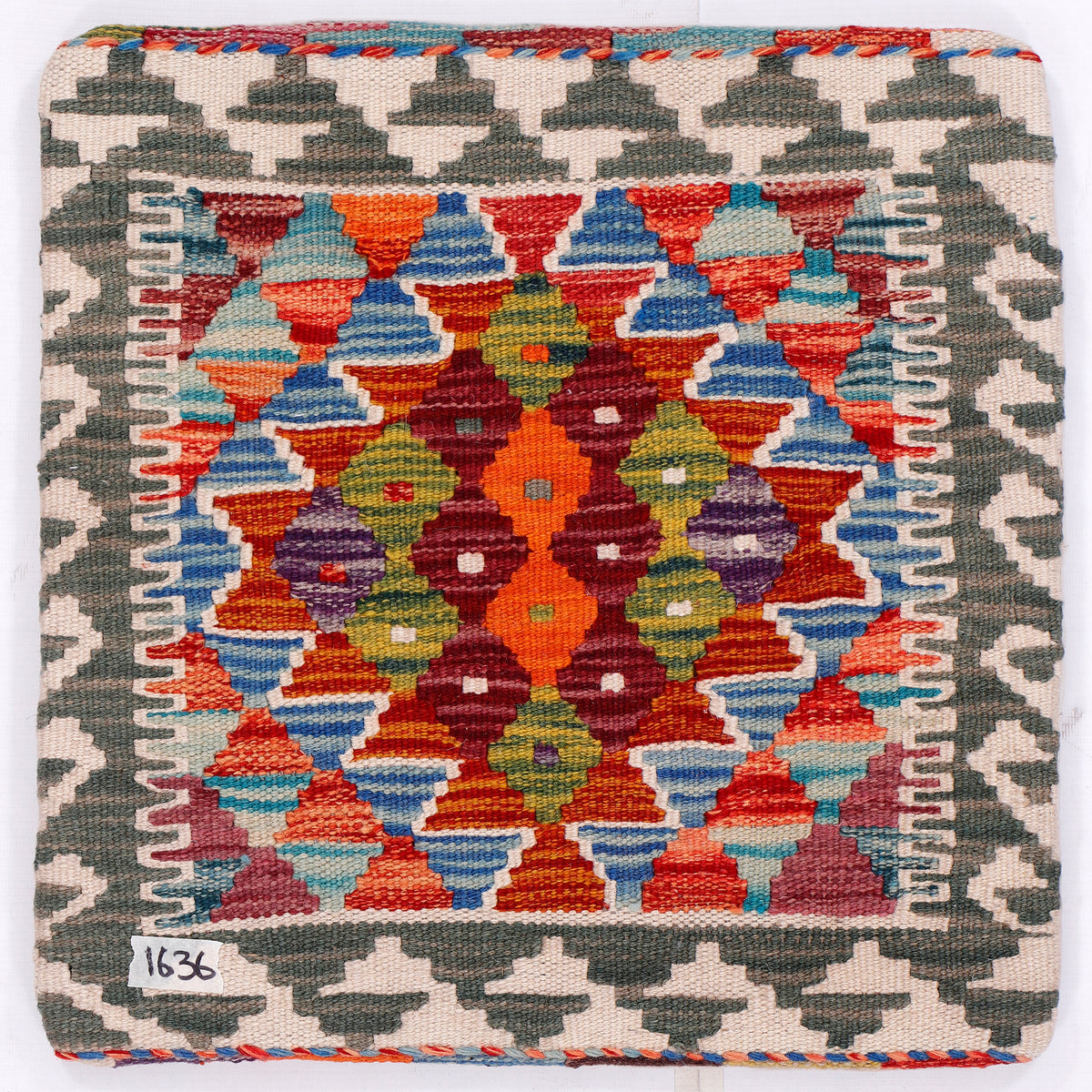 Kilim cushion cover 45x45 cm, close view of colorful geometric tiles with red edging