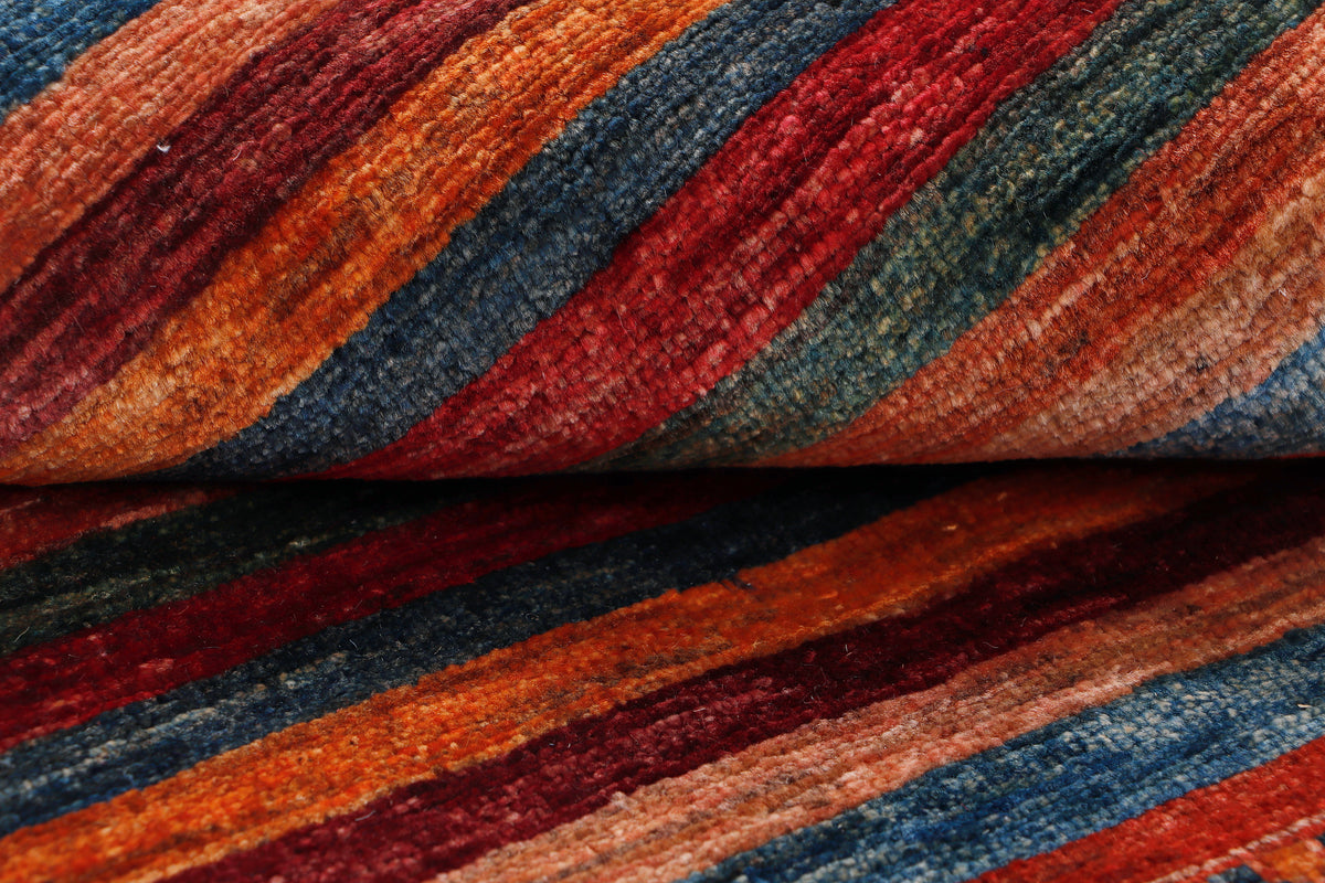 Close-up of multicolor striped rug weave in red, orange, blue, and teal