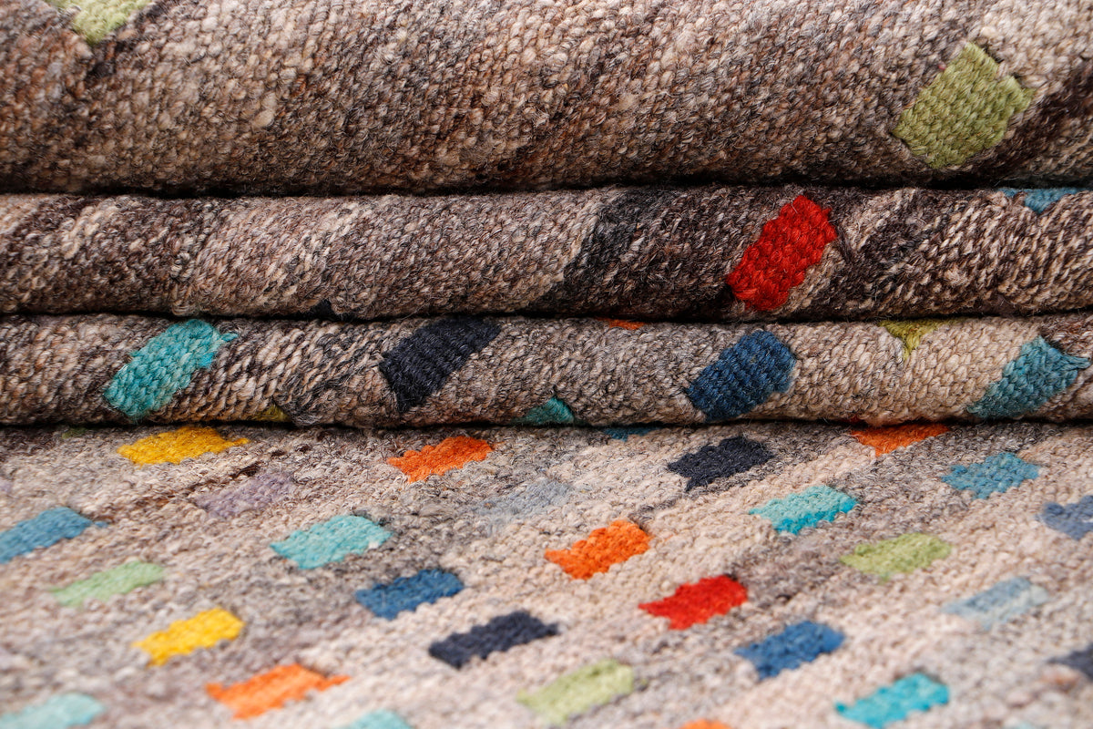 Close-up Kelim rug texture with gray fibers and scattered multicolor motif shapes