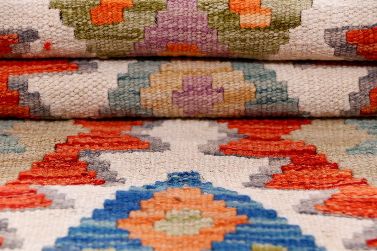 Kilim rug fabric close-up with woven texture and small multicolor floral-like motifs