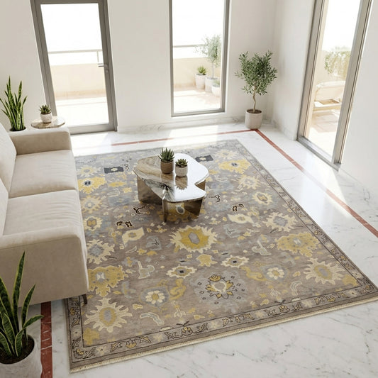 Oushak rug with gray field and yellow floral motifs, centered on a room floor.