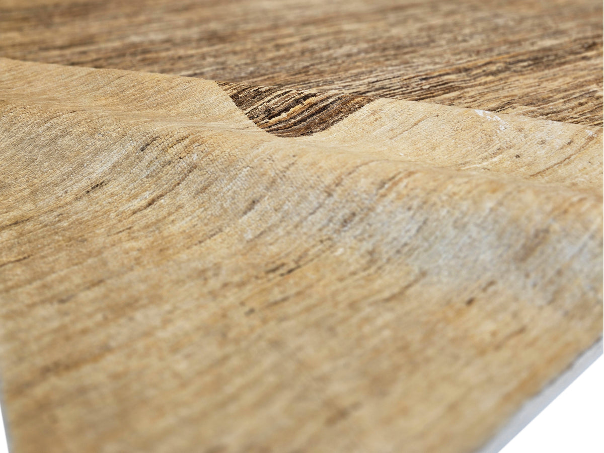 Beige flatweave rug with dark brown stripe detail near the edge