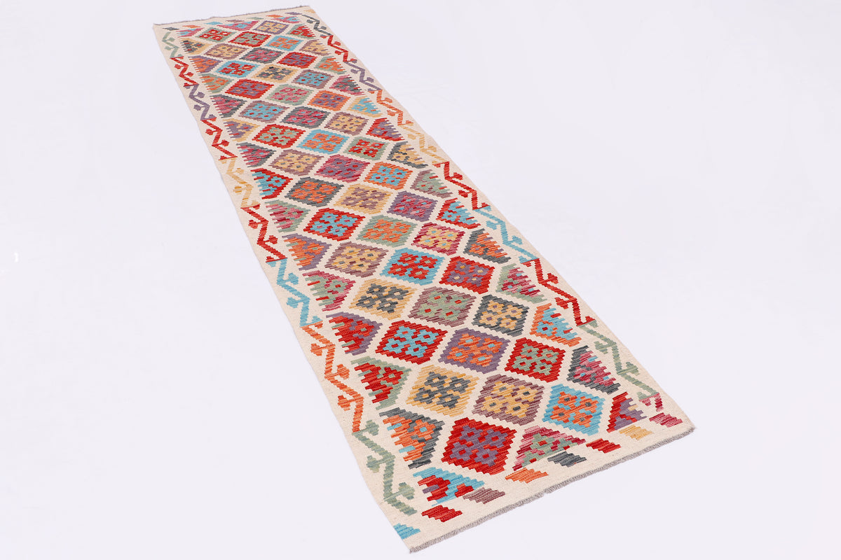 Kilim rug runner with red, blue and orange geometric squares on cream background