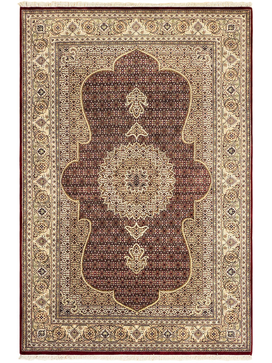 Patterned area rug with central arch medallion in dark red and beige with border