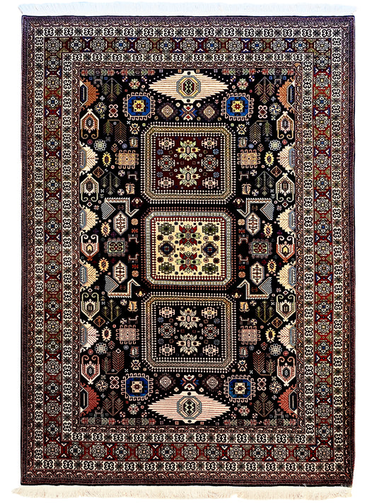 Azerbaijan rug, dark navy field with red border and geometric medallions, fringed edge