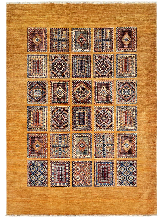 Rectangular area rug with warm gold field and a grid of multicolor geometric medallion blocks