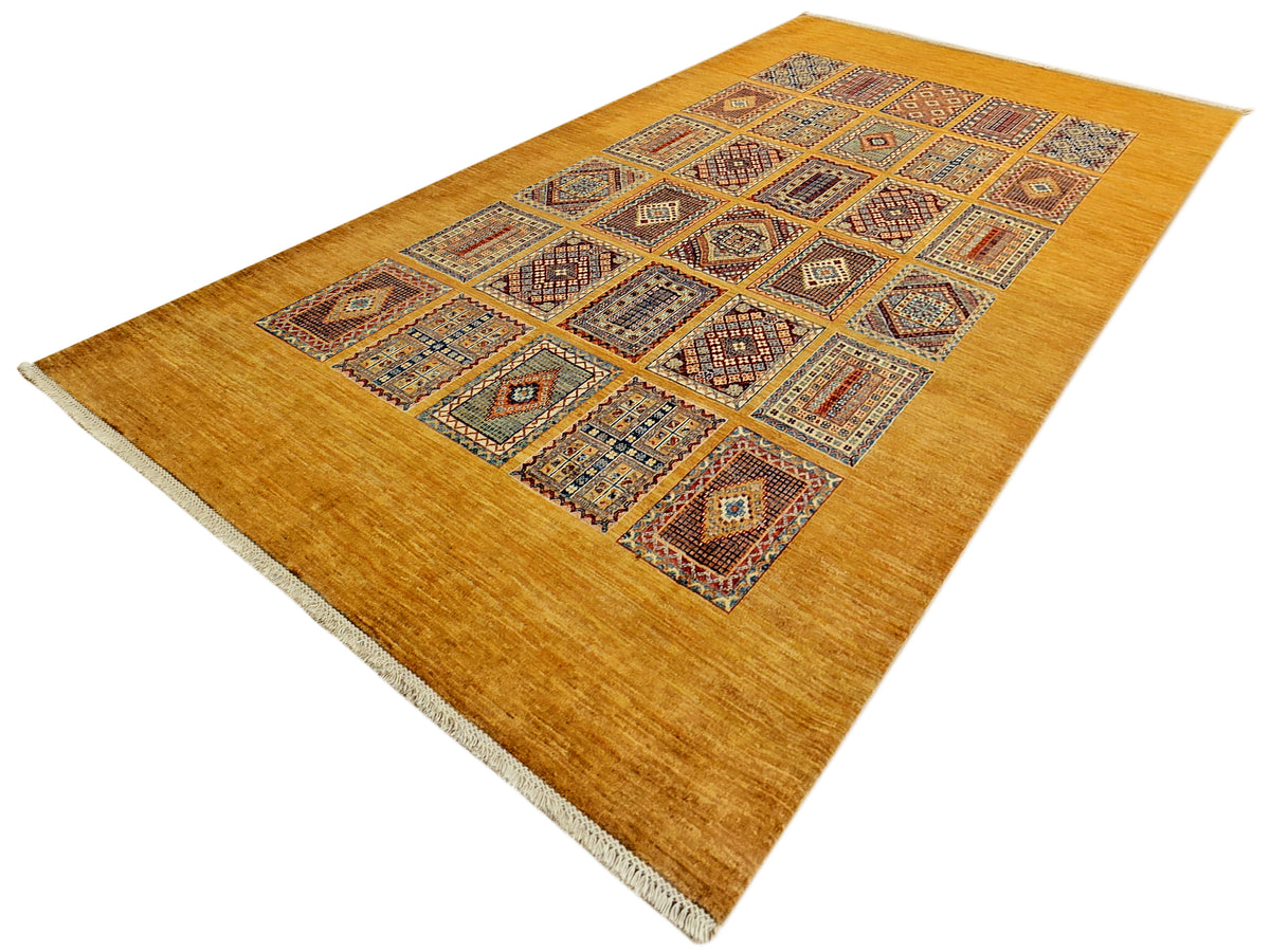 Rectangular area rug with warm gold background and multicolor diamond-pattern central medallion design