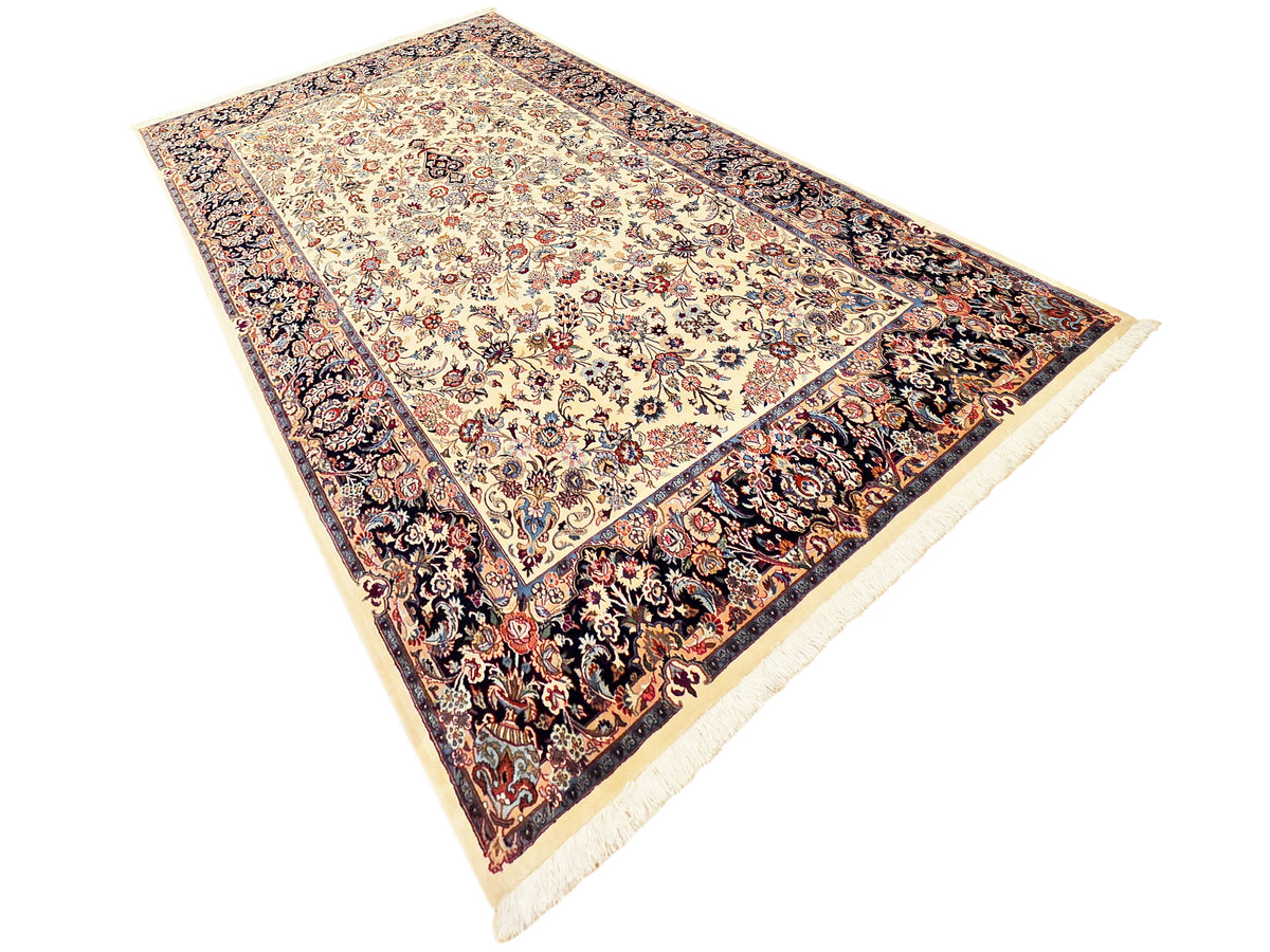 Rectangular rug laid diagonally, cream center with floral medallions and dark side border