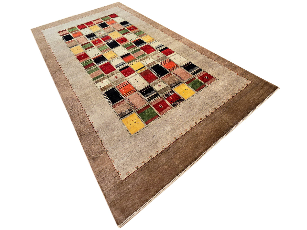 Loribaft rug with beige central panel, multicolor blocks, and brown outer border