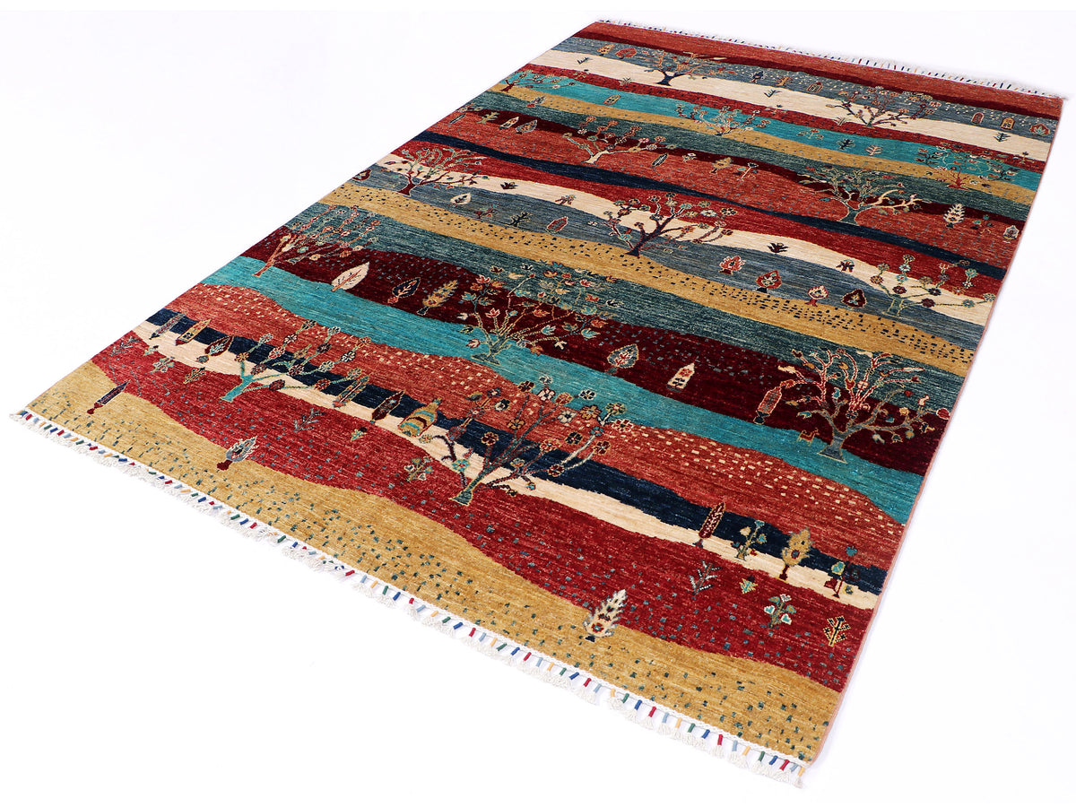Ariana Gabbeh rug angled with red center field, teal stripes, and village-like motifs.