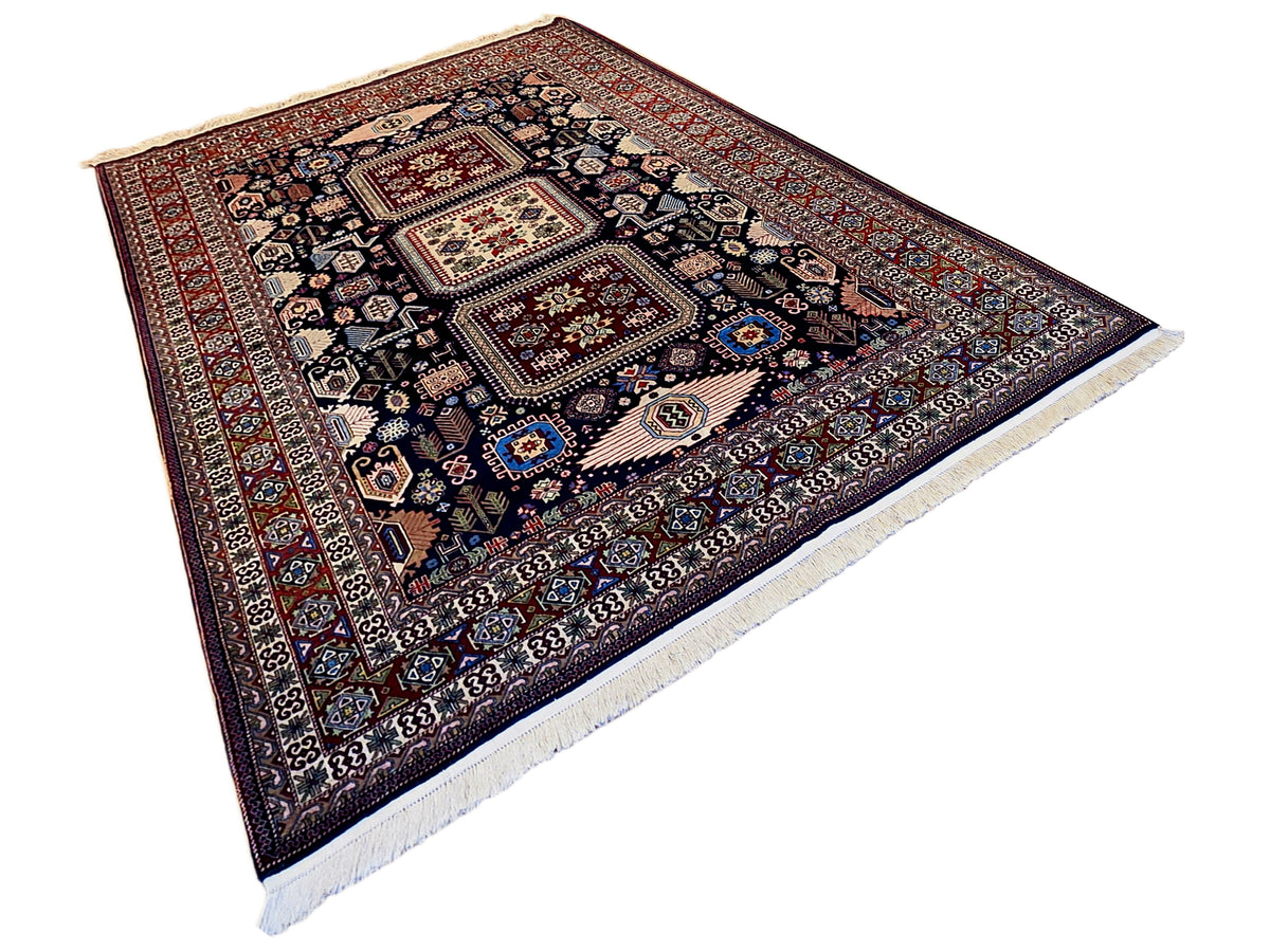 Azerbaijan rug, dark navy ground with red border and blue-and-cream ornament pattern