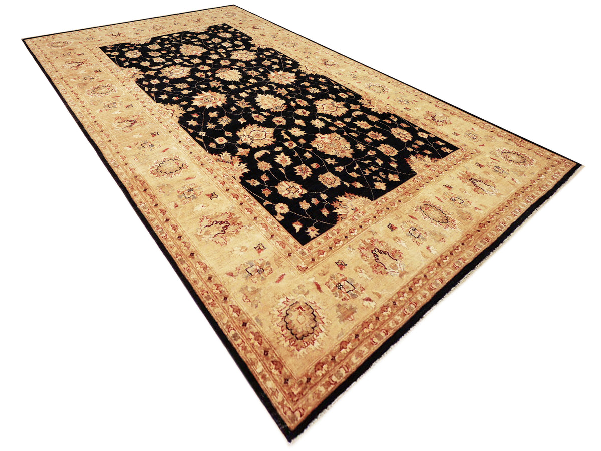 Afghan rug with black floral center and beige border, angled view on plain background.