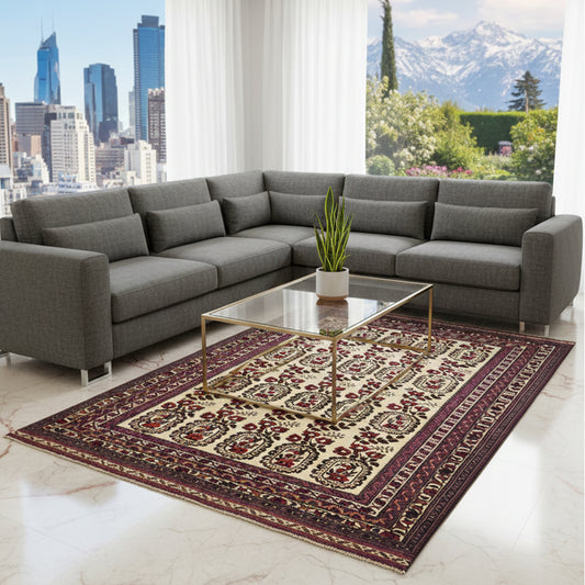 Cream and burgundy area rug with navy ornamental medallion border, placed on floor.