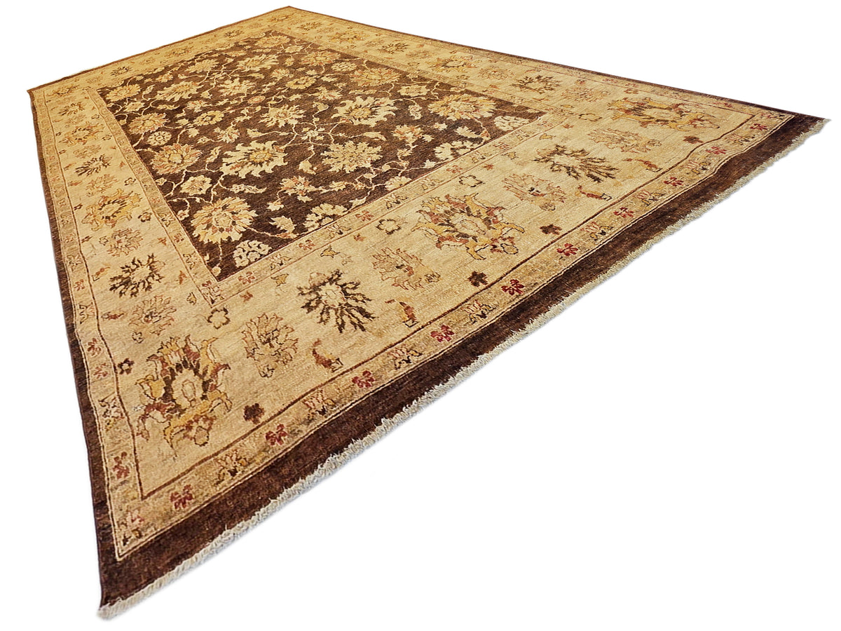 Vintage-style rug with tan field, dark-brown floral vines, and red accents along border