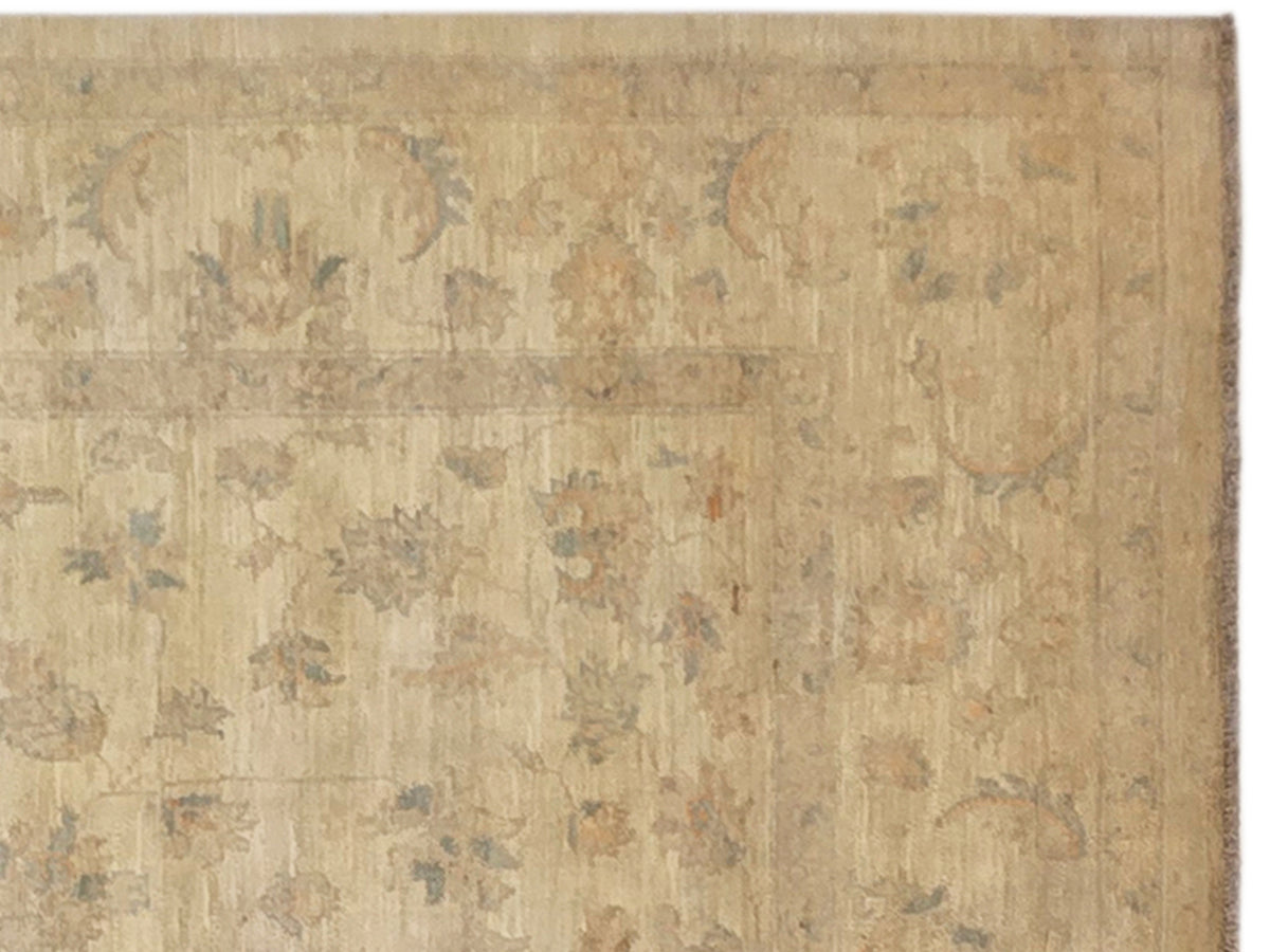 Beige rug close-up with mottled faded pattern in light blue and tan
