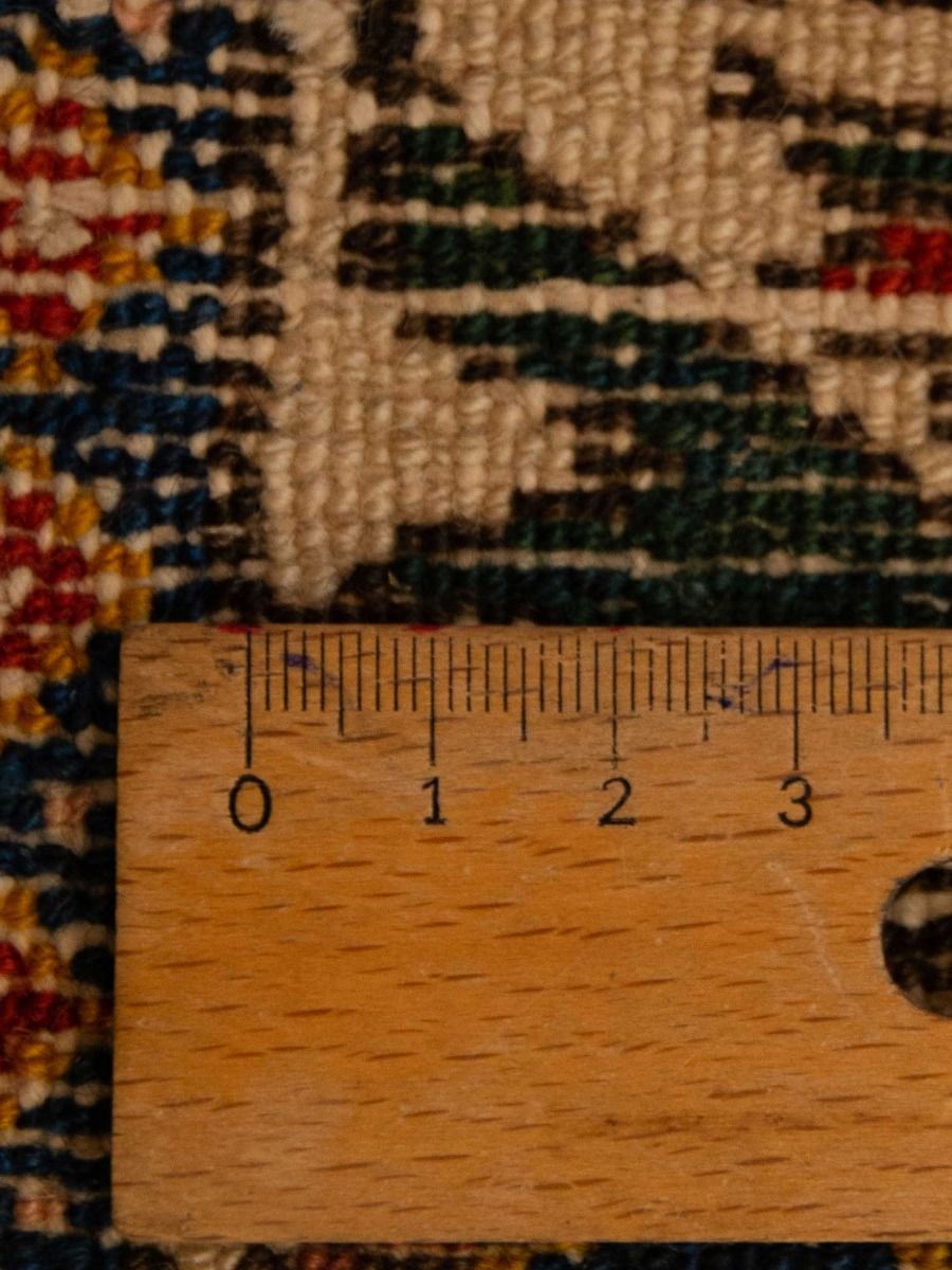 Bakhtiari rug close-up weave in beige with red and dark blue pattern