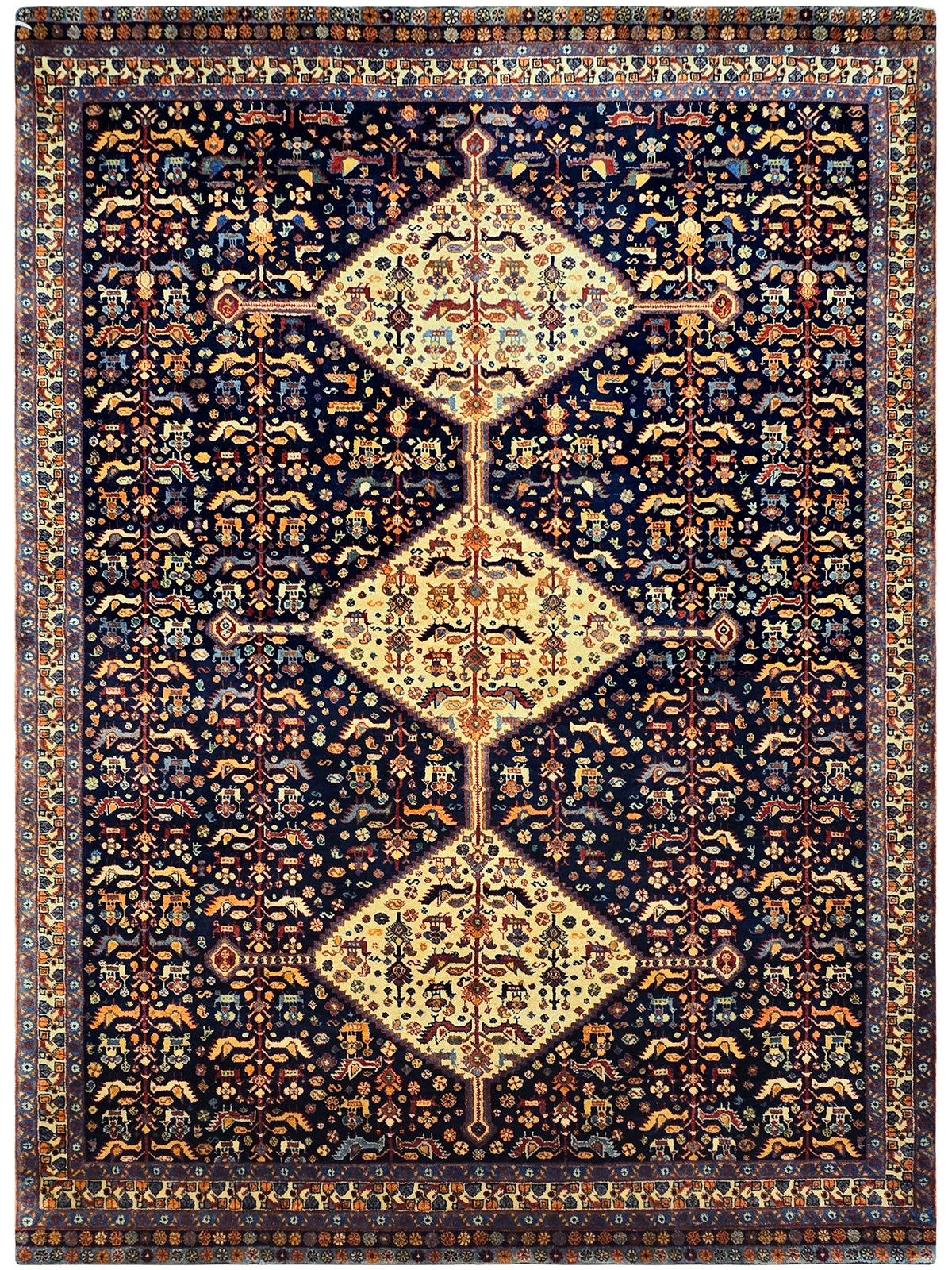 Navy rug with central diamond motif, cream ground, and ornate orange floral pattern