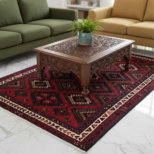 Red, navy, and cream geometric rug with diamond motifs and border trim