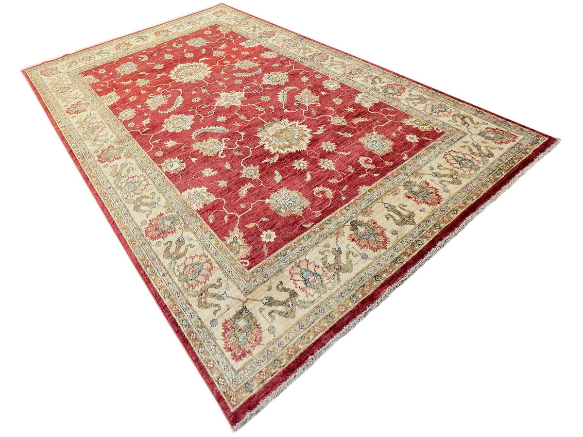 Rectangular red rug with cream field, ornate medallions, and decorative border.