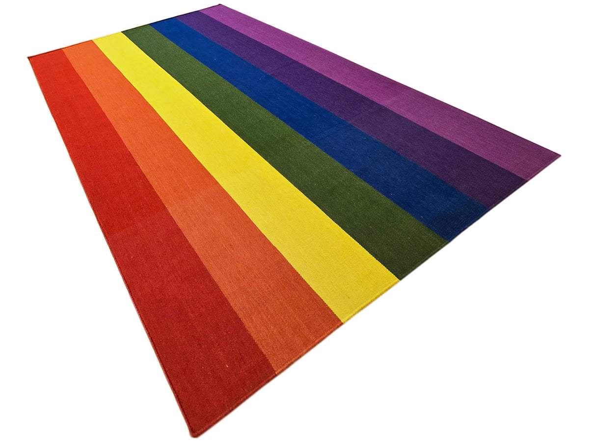 Colorful striped rug with wide purple, red, yellow, green, and blue bands, triangular crop