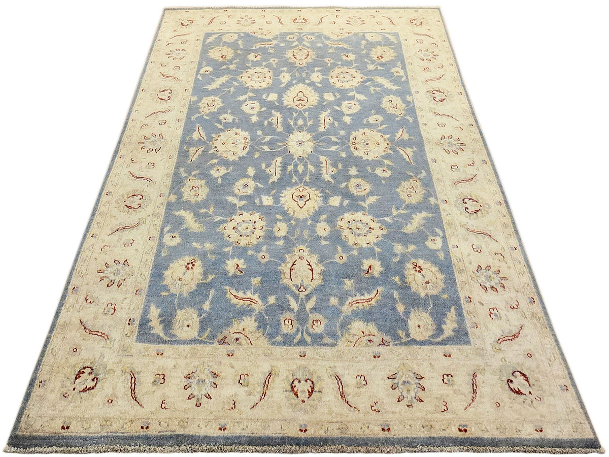 Afghan rug with cream border and central blue panel filled with floral medallions