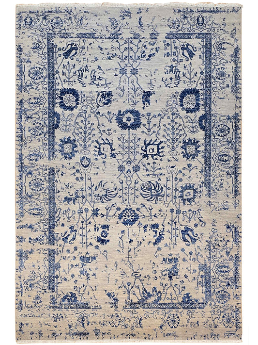 Beige and blue patterned area rug with symmetrical medallion motifs and border, flat lay.