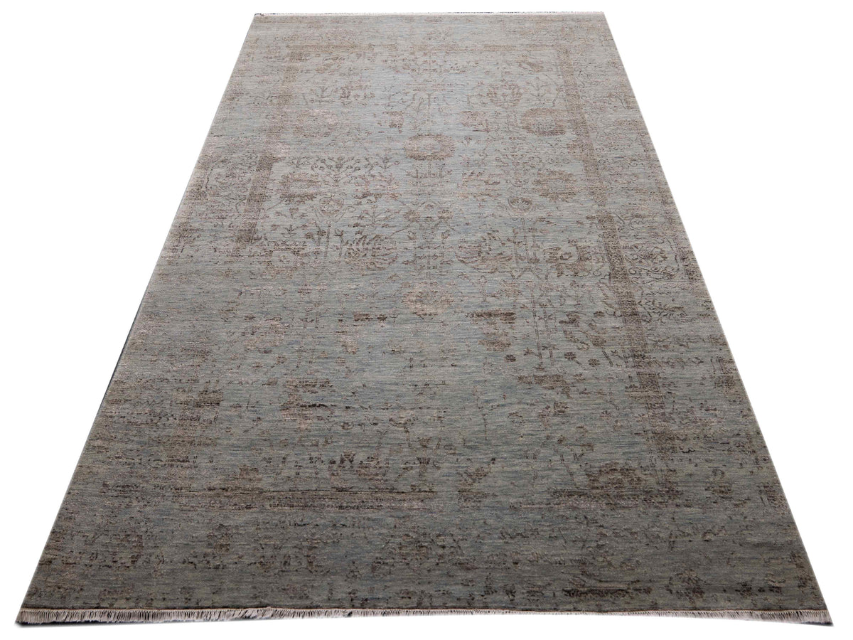 Large light gray distressed area rug with mottled abstract design