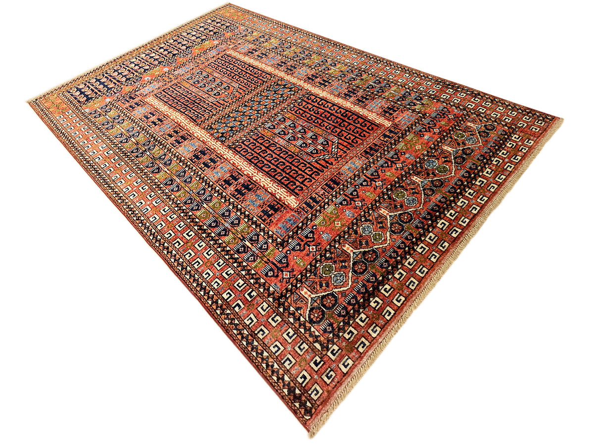 Geometric Turkmen-style rug with red, rust, navy, and beige diamond motifs