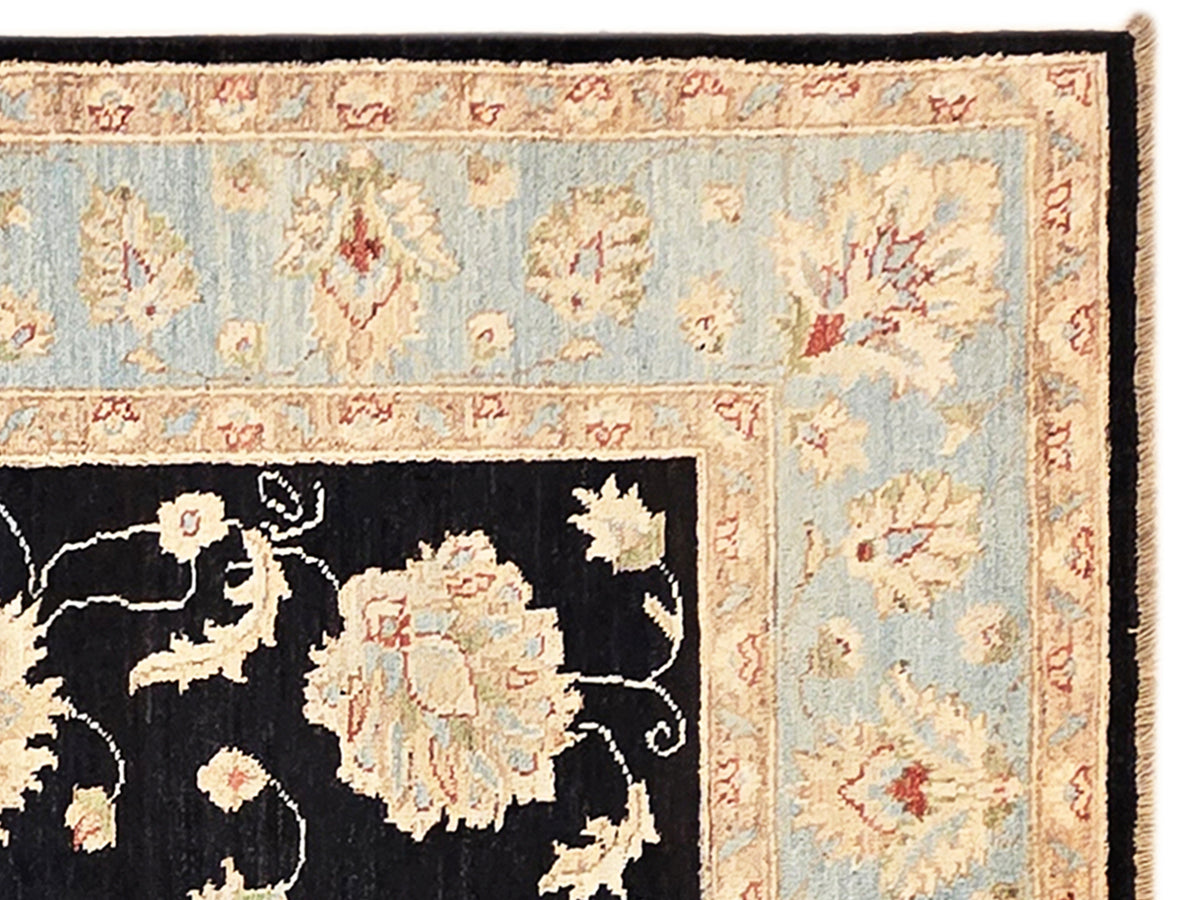Rug border close-up with light blue field, beige florals, and thin red accents