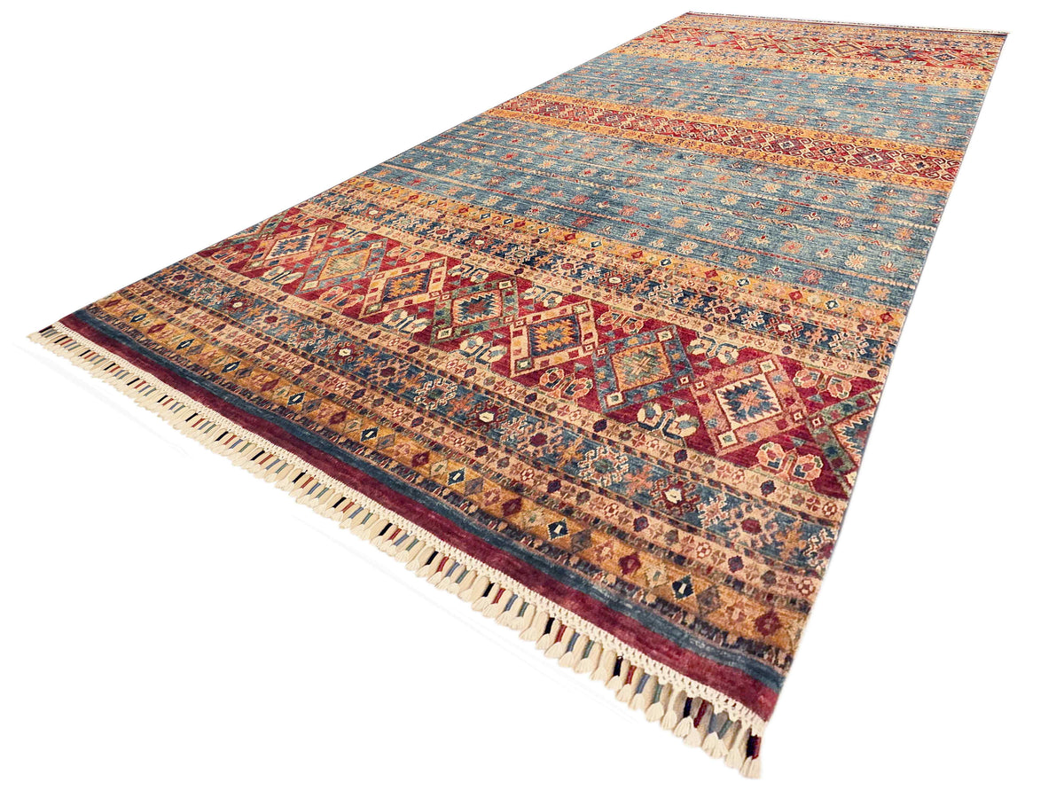 Khorjin-style rug full view with multicolor geometric pattern and cream tassel fringe.