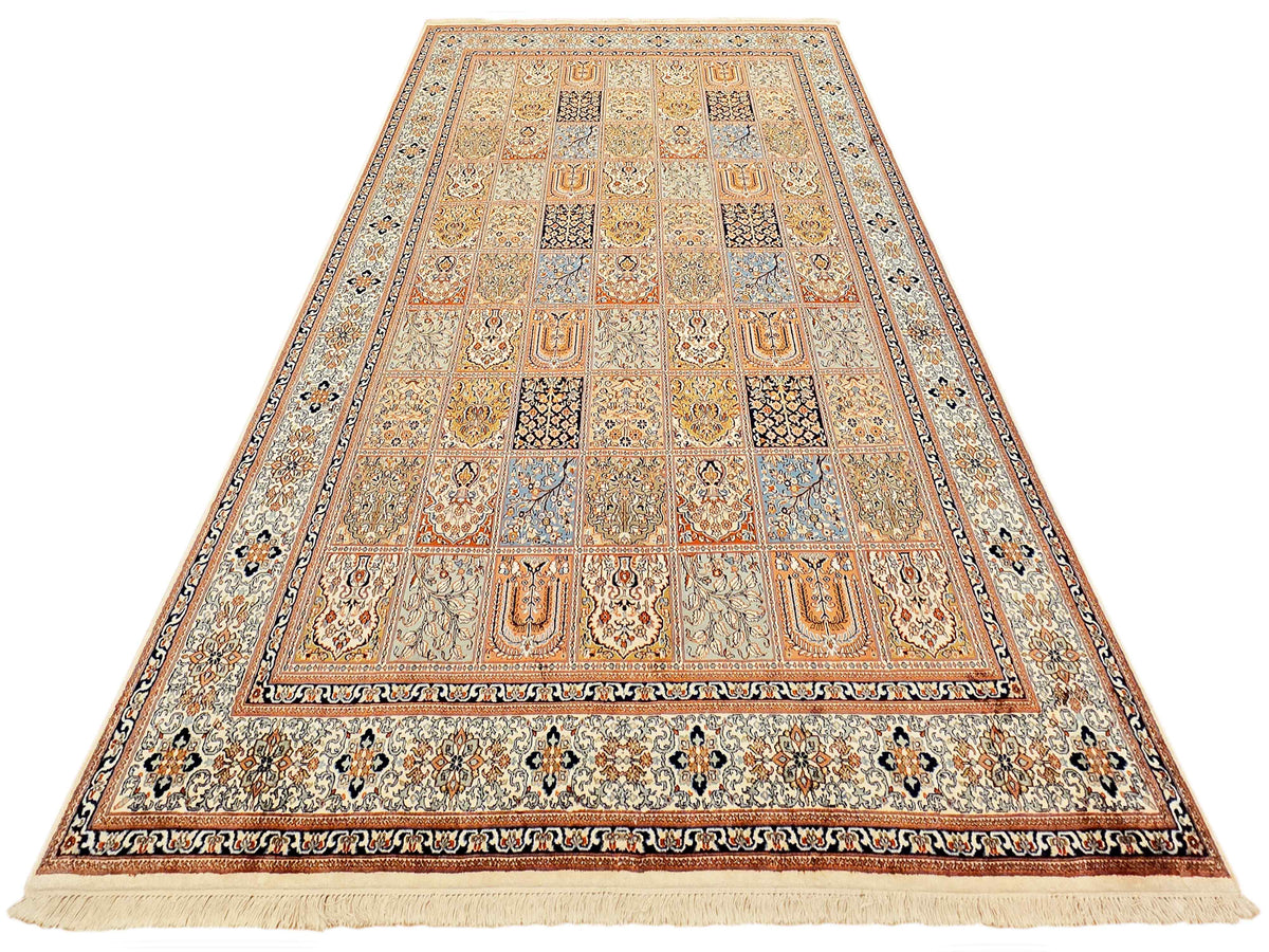 Rectangular cashmere silk rug with central panel, medallion details, and fringed hem