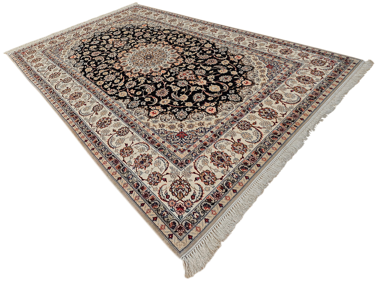 Isfahan rug top view: black central medallion on light background with patterned border and fringe