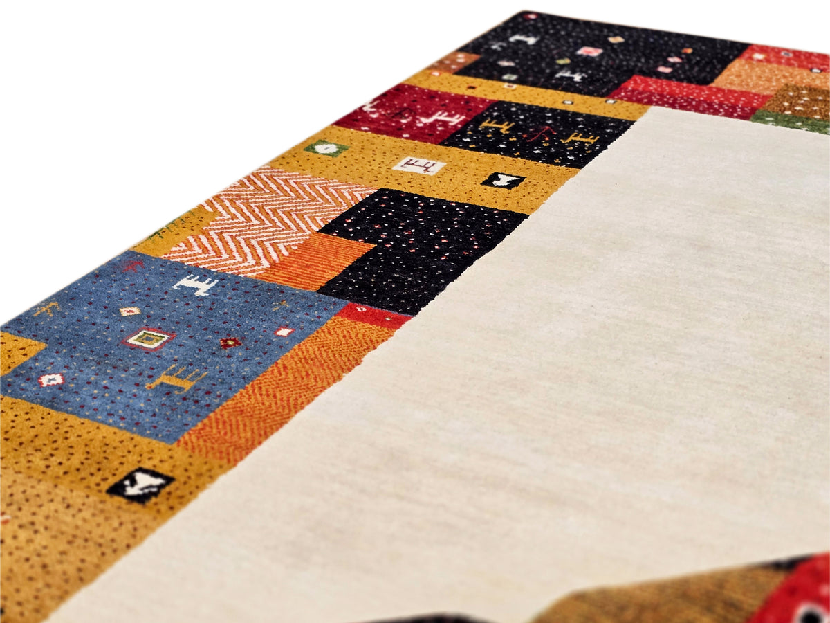 Patchwork rug corner detail with cream center and orange, blue, black blocks