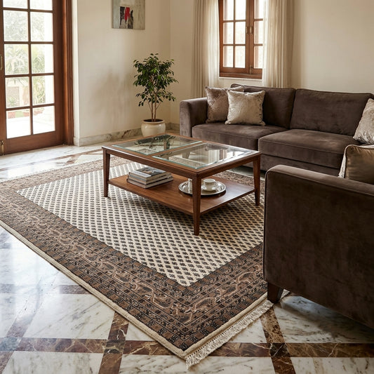 Large geometric rug with ornate dark border, white lattice center, and fringed trim
