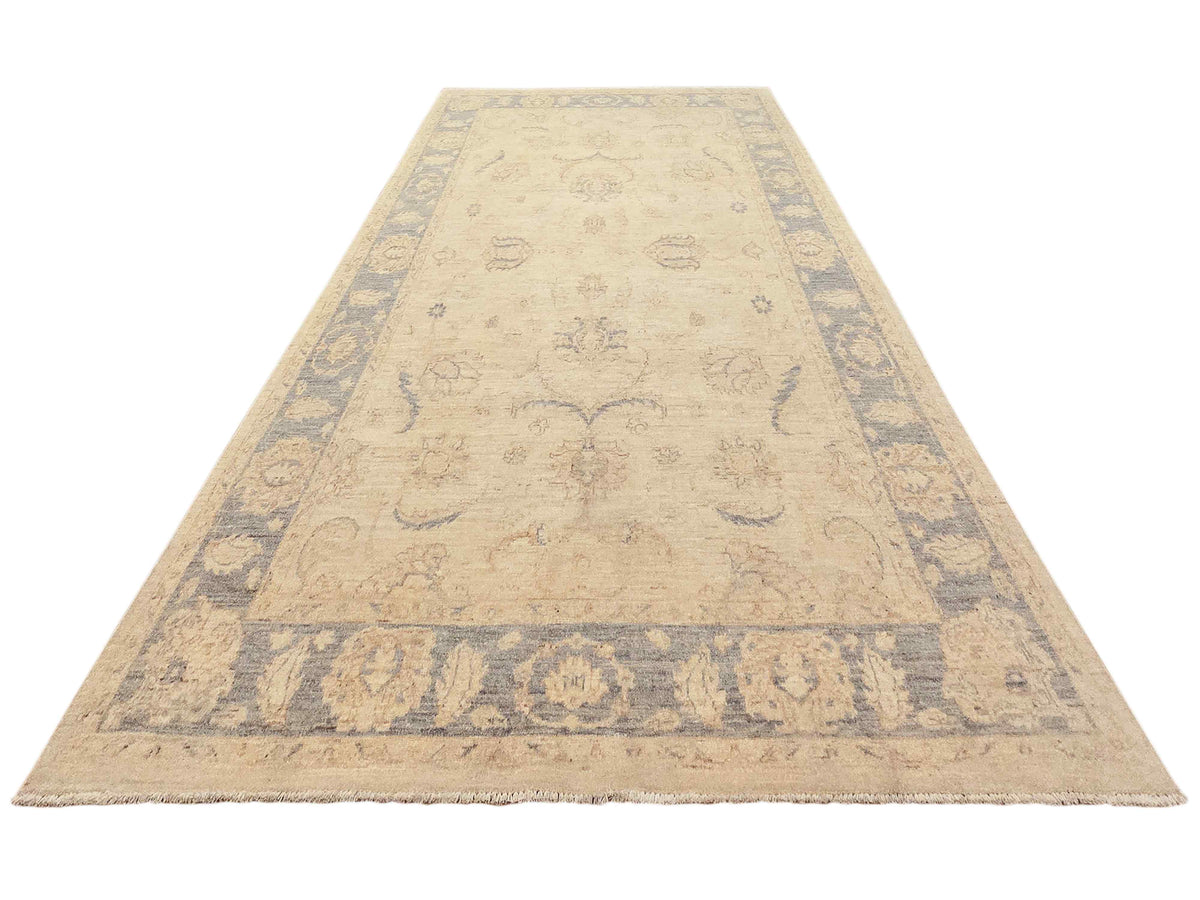Beige and light blue Persian-style area rug with ornate border, laid flat