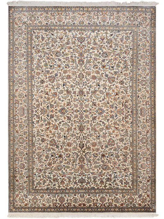 Beige silk rug with large medallion pattern, detailed border, and fringe trim