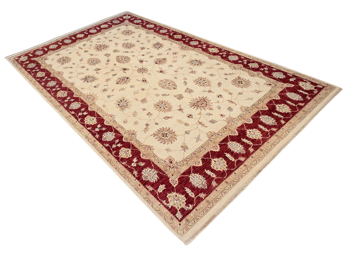 Cream wool rug with burgundy lattice border and central floral medallion
