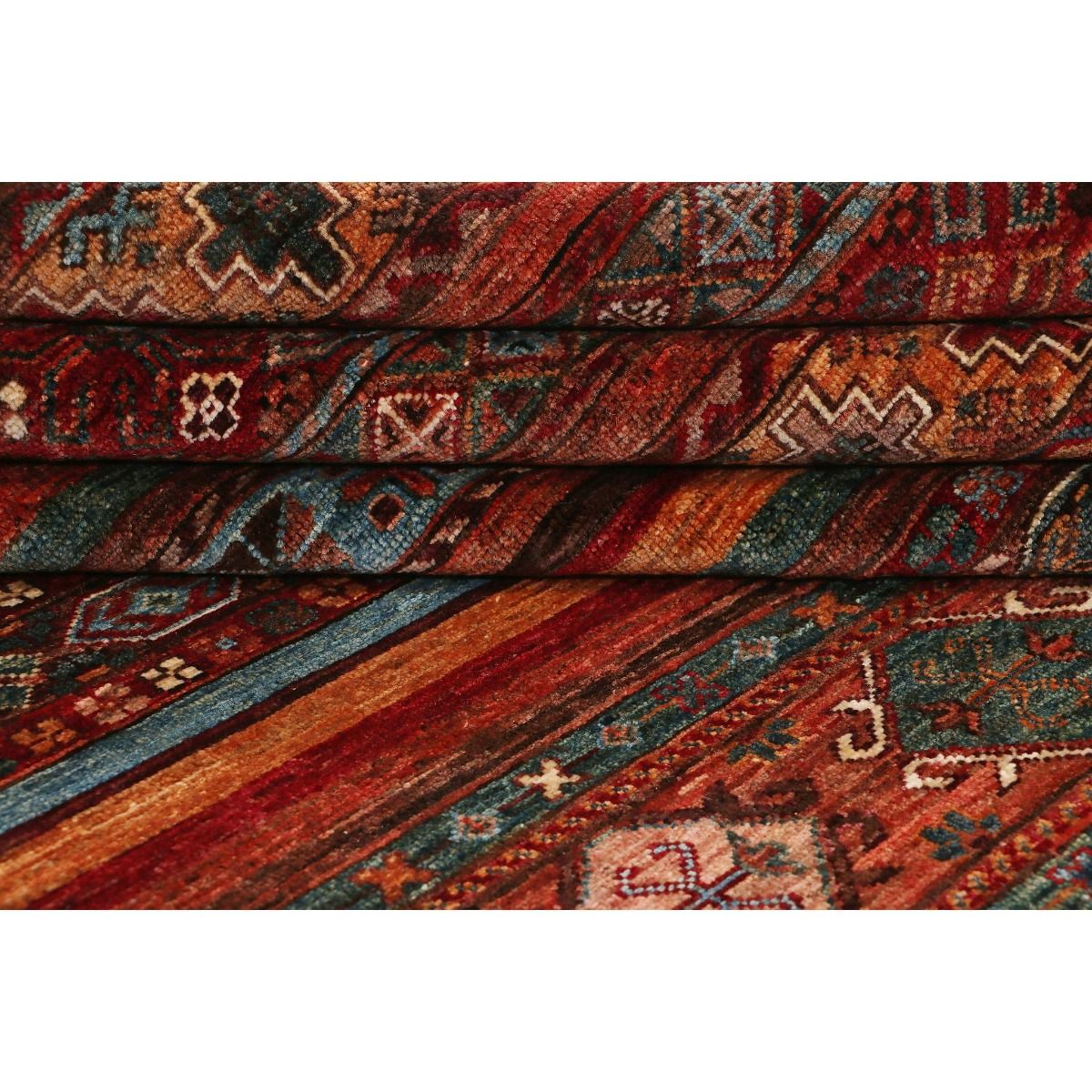 Khorjin Samarkand rug close-up of red, teal, and rust woven pattern.