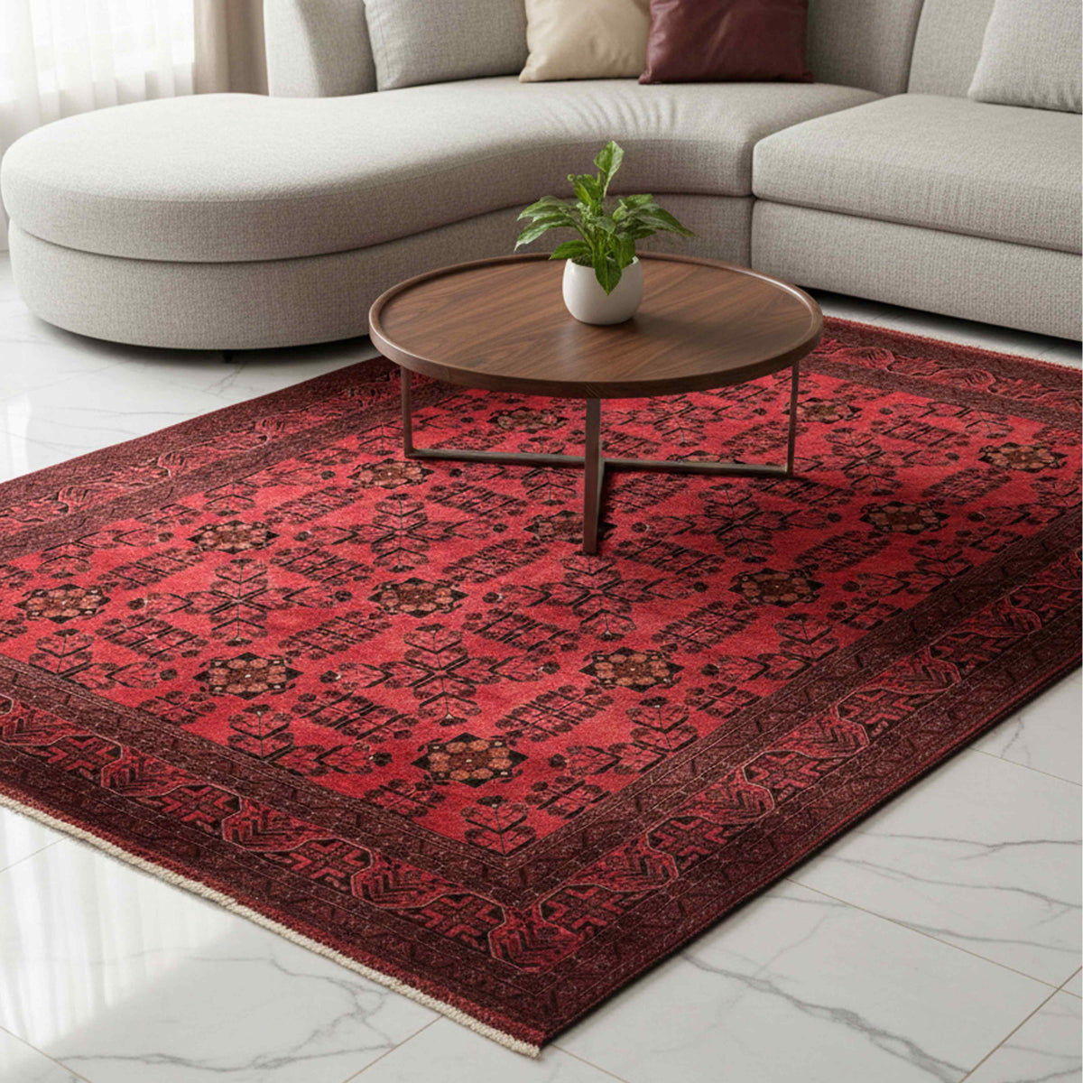 Red area rug with dark geometric pattern, bordered edge, and flat woven texture.