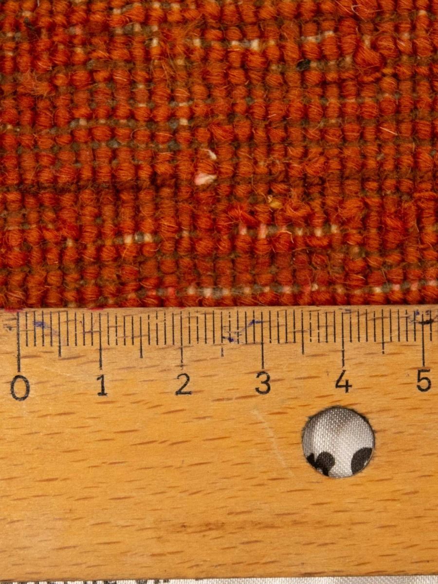 Loribaft rug pile close-up in orange-brown, textured woven surface