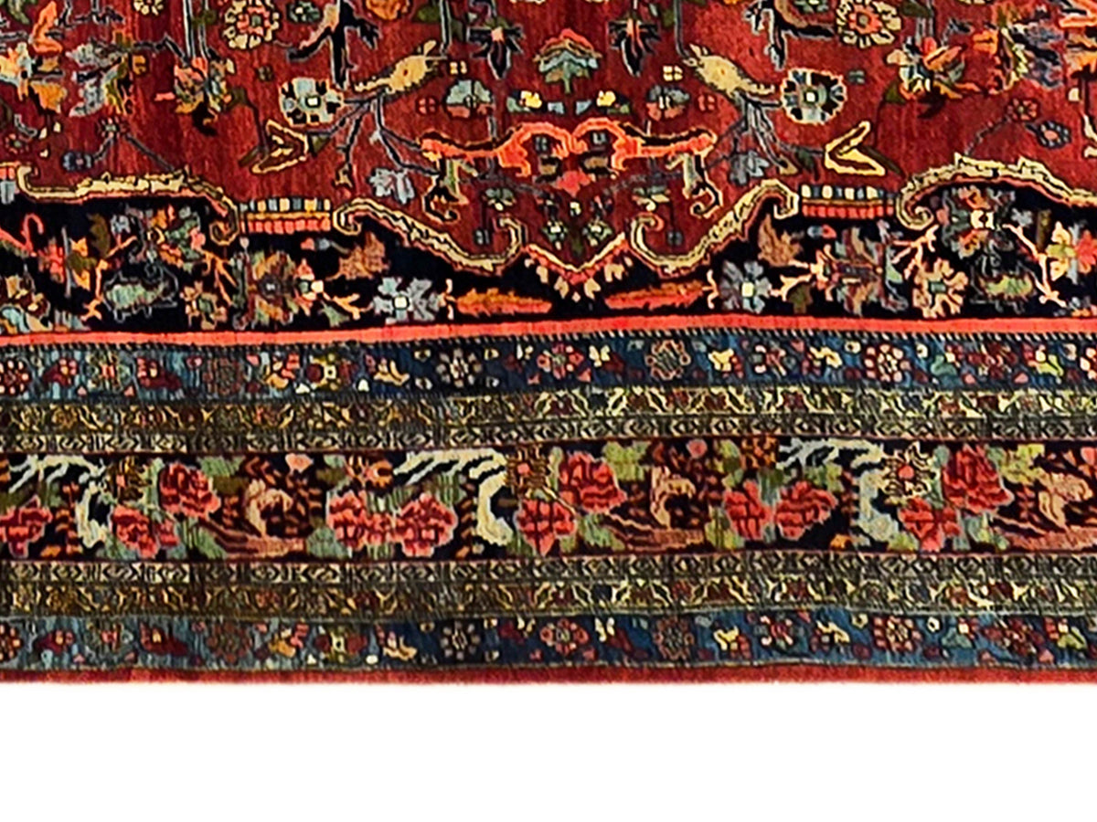 Rug border detail with red ground, dark blue bands, and ornate geometric trim