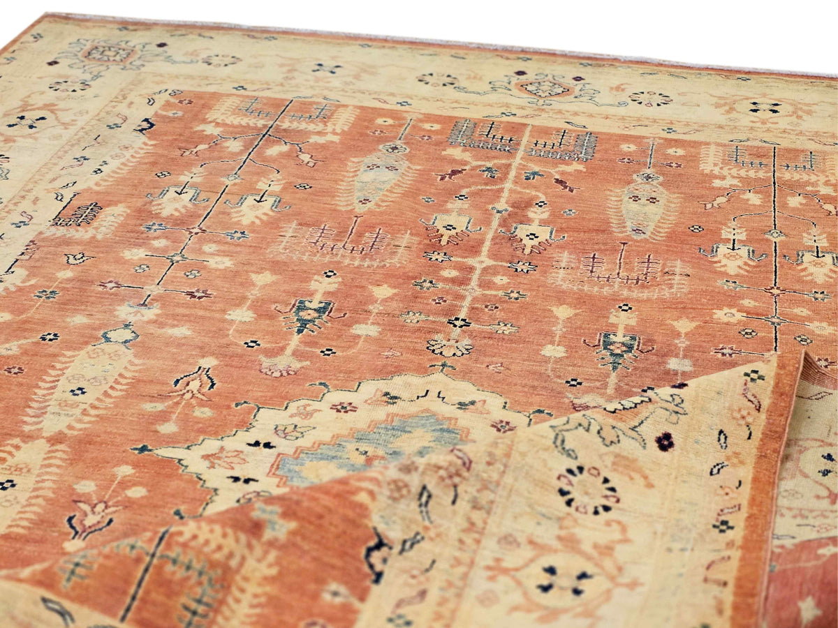 Rug surface detail in terracotta orange with intricate teal and navy accents