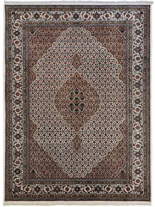 Evenly framed patterned area rug with brown center medallion and ivory motif border.