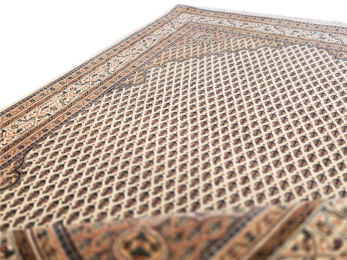 Rug close-up showing dense ivory lattice pattern over dark brown base
